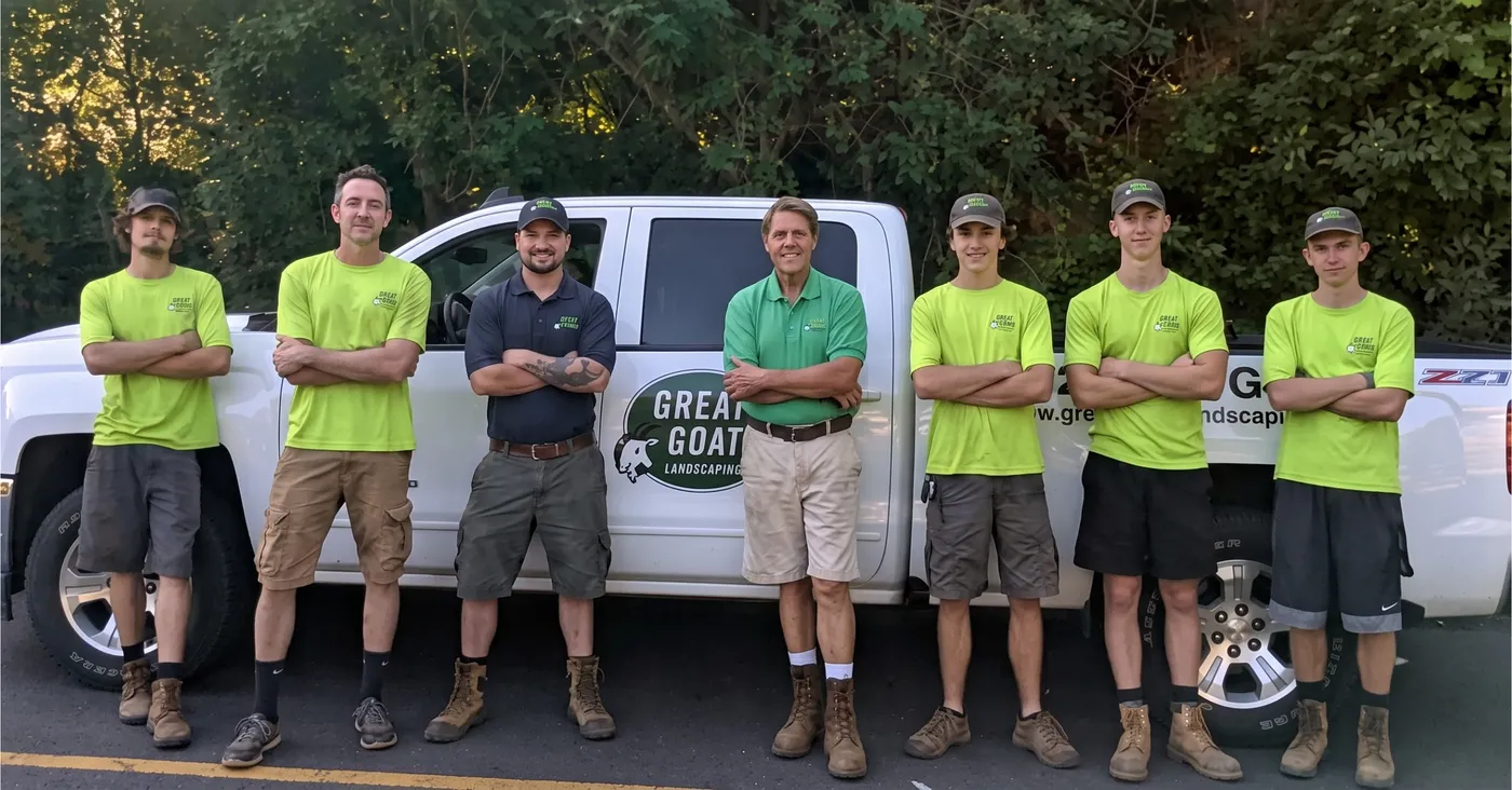 The Great Goats Landscaping crew standing in front of a company truck — owner Mike Olson with his team in the Twin Cities